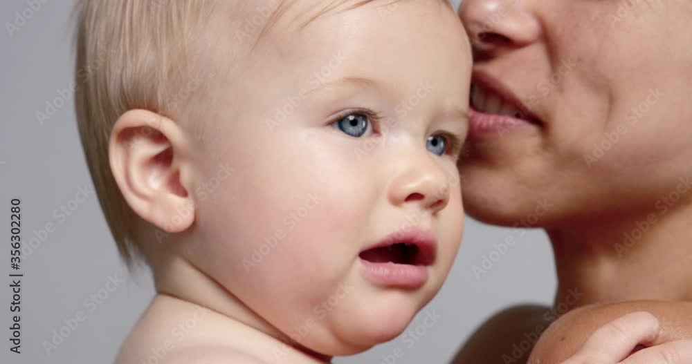 SLO MO CU Smiling mother holding baby daughter (6-11 months) SLO MO CU Smiling mother holding baby daughter (6-11 months)