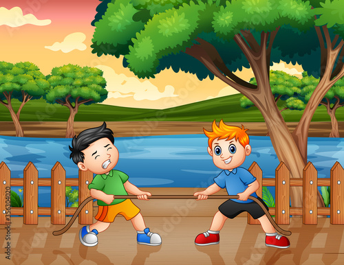 Two boy playing tug of war at the pier