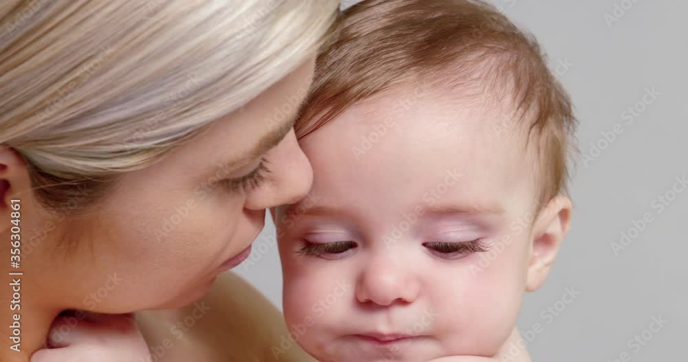 SLO MO CU Young mother hugging and kissing baby son (6-11 months) SLO MO CU Young mother hugging and kissing baby son (6-11 months)