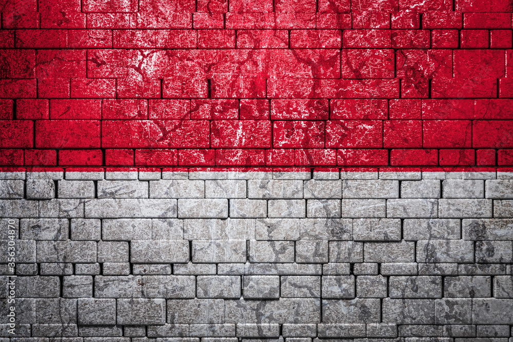 National flag of Indonesia on brick wall background.The concept of national pride and symbol of the country. Flag banner on stone texture background. National flag of Indonesia on brick wall background.The concept of national pride and symbol of the country. Flag banner on stone texture background.