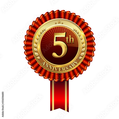 Celebrating 5th anniversary logo, with golden badge and red ribbon isolated on white background.