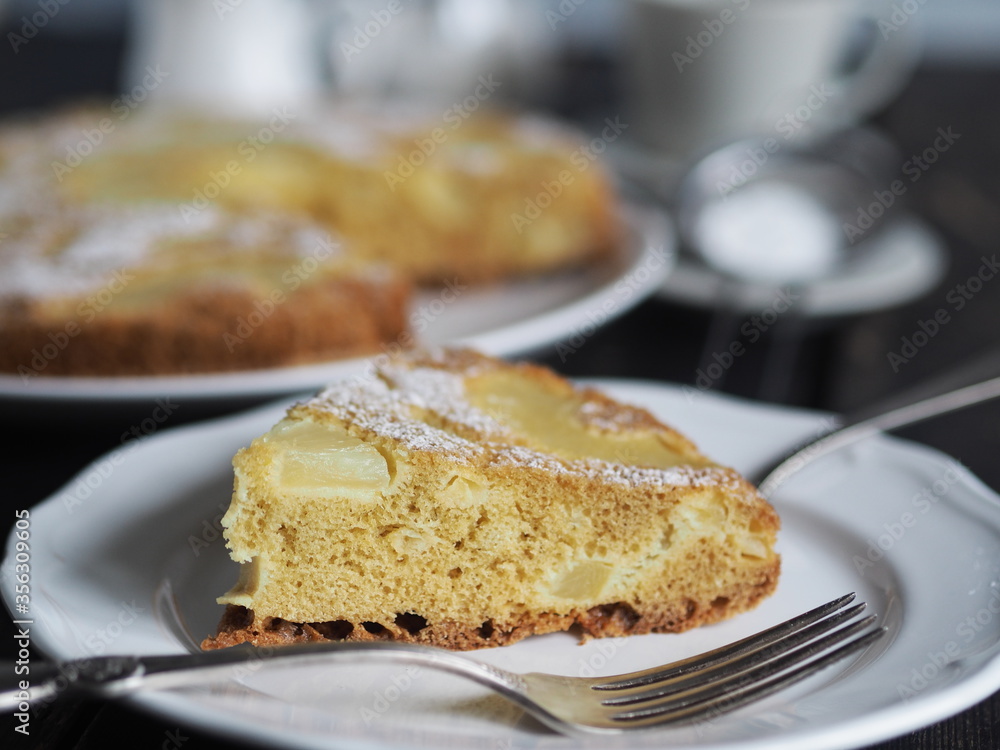 Sponge cake with pineapple on a dark wooden table.Home cooking. Sponge cake with pineapple on a dark wooden table.Home cooking.