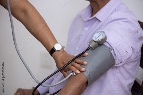 nurse taking blood pressure to a patient