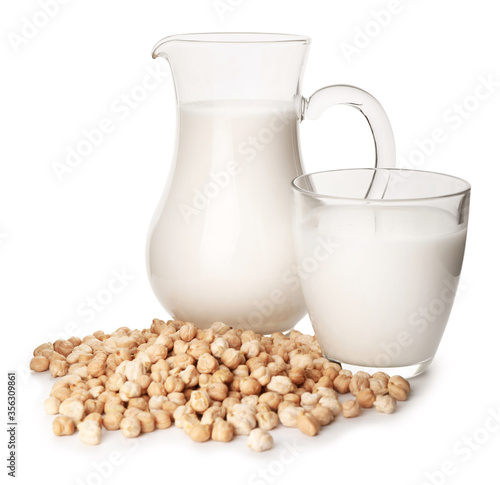 Glass and jug of tasty chickpea milk on white background