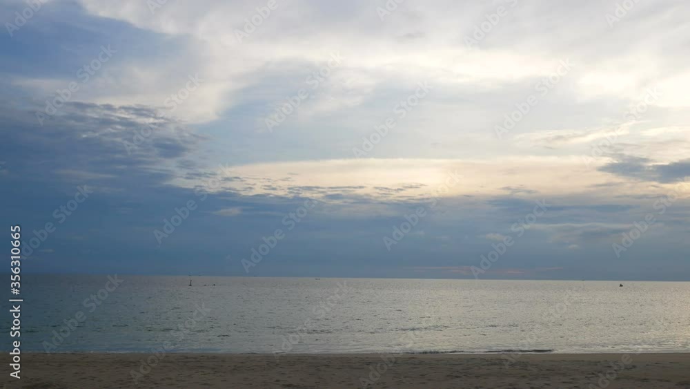 moving water wave hit sand shore coast, nobody on beach, skyline horizon beautiful cloudy dark blue sky background at evening time, nature and travel concept moving water wave hit sand shore coast, nobody on beach, skyline horizon beautiful cloudy dark blue sky background at evening time, nature and travel concept