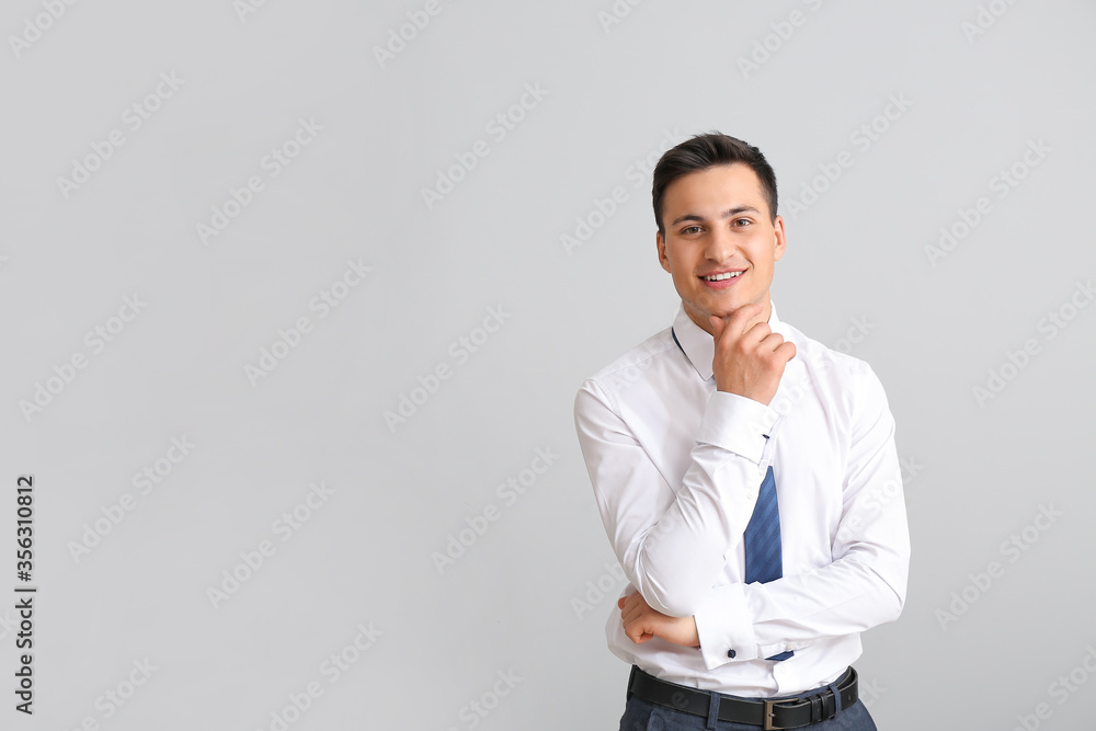 Portrait of handsome businessman on grey background Portrait of handsome businessman on grey background