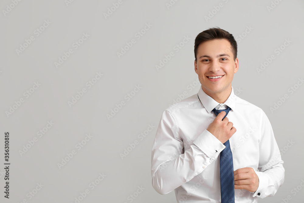 Portrait of handsome businessman on grey background Portrait of handsome businessman on grey background