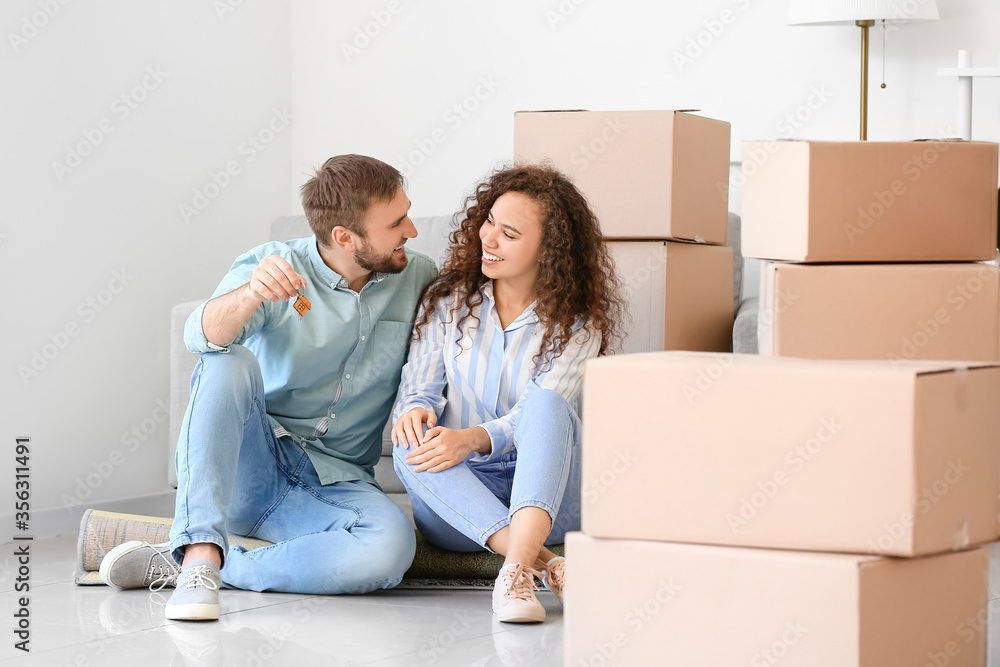 Happy young couple in their new flat on moving day Happy young couple in their new flat on moving day