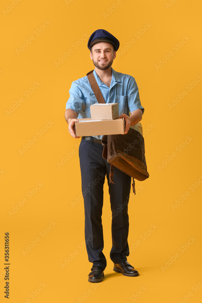 Handsome young postman on color background Handsome young postman on color background