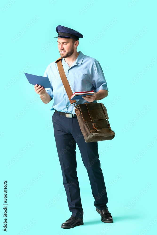Handsome young postman on color background Handsome young postman on color background
