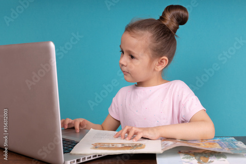 Preteen schoolgirl doing her homework with digital tablet at home. Child using gadgets to study. Education and distance learning for kids. Homeschooling during quarantine. Stay at home entertainment.