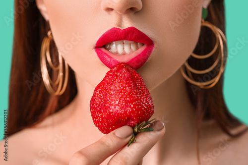 Sexy young woman with strawberry, closeup