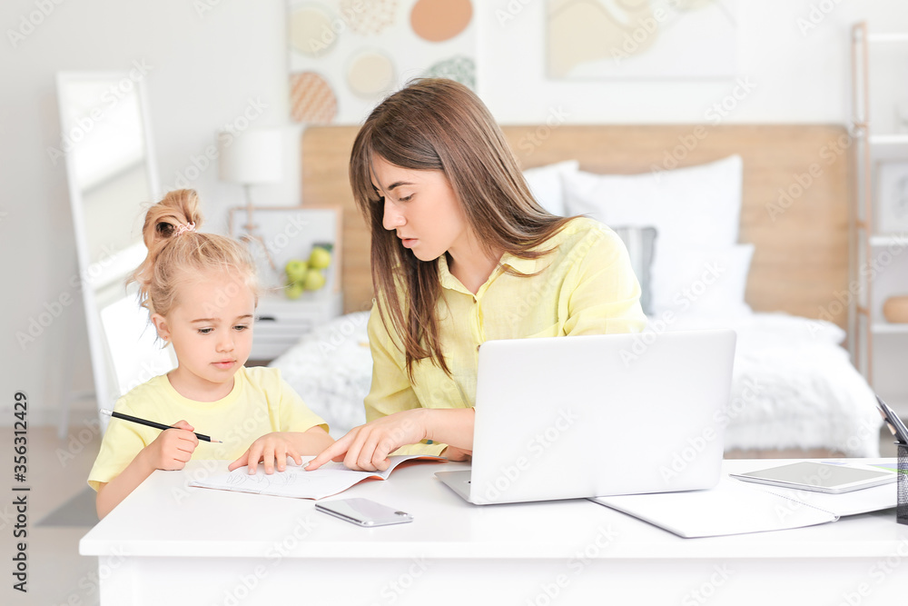 Working mother with her little daughter at home Working mother with her little daughter at home