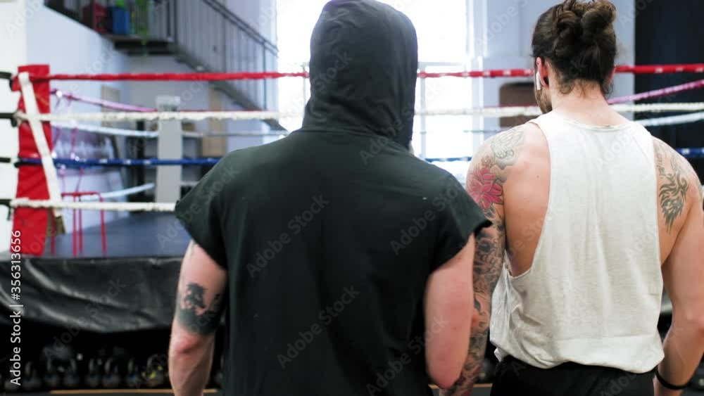 MS POV Rear view of two young men walking in gym / Milan, Italy