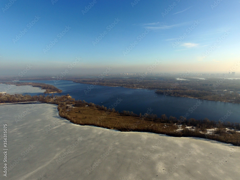 Aerial view of the Dnepr river in Kiev at winter (drone image)