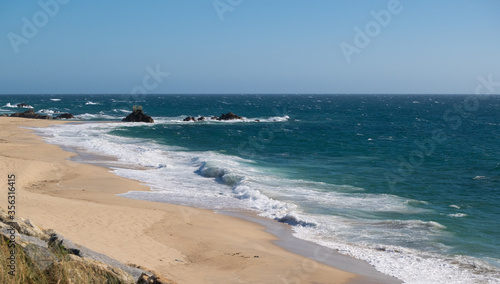 Beautiful sandy beach of Vila do Conde, Portugal with bright blue sky and turquoise sea on a sunny day in summer © Barry