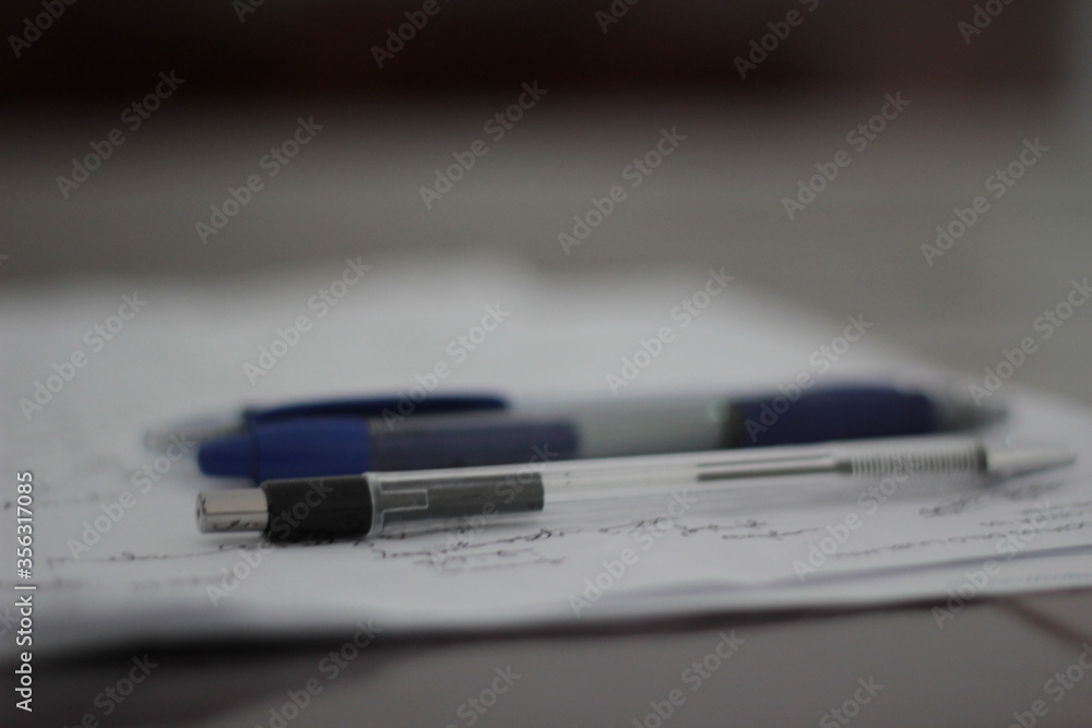 Penciles and pens on a white paper. Penciles and pens on a white paper.