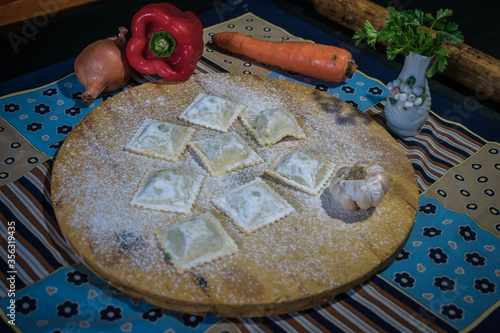 homemade ravioli with vegetables, bell peppers, garlic and parsley