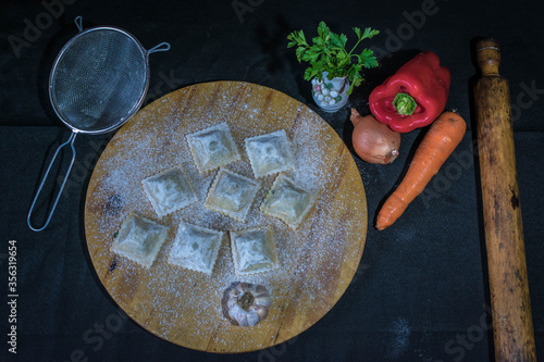 homemade ravioli with vegetables, bell peppers, garlic and parsley