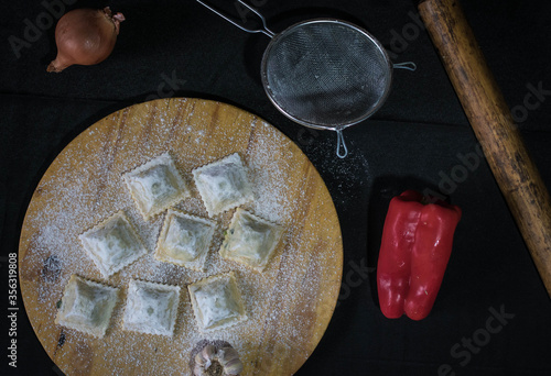 homemade ravioli with vegetables, bell peppers, garlic and parsley