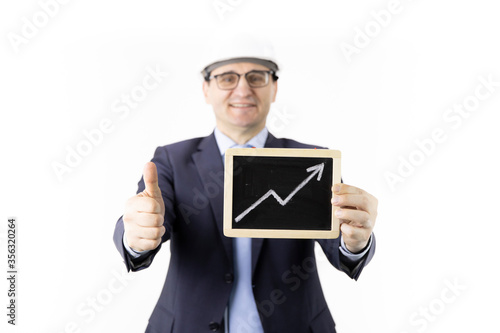 Happy businessman holds sign with up arrow rising oil quotes showing like sign. Oil refinery industry, market strengthening, growth of quotes, sales and supply growth, petroleum engineering concept photo