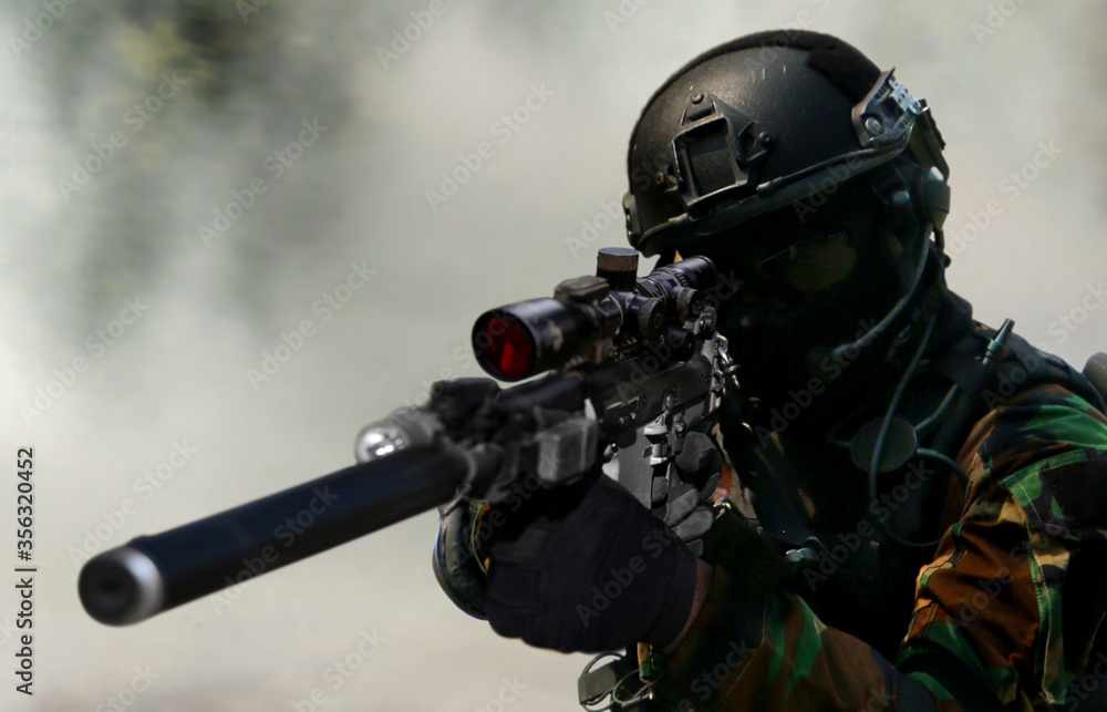 Army sniper during the military special operation in close up Army sniper during the military special operation in close up