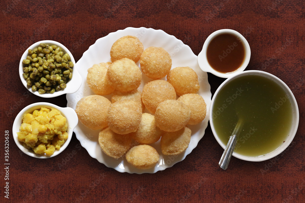 Fototapeta premium A popular Indian snack called pani puri. Pani puri is a popular food item in India it is also known as puchka or gol gappe.
