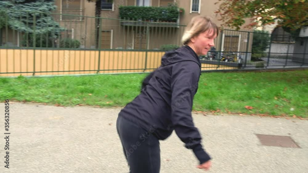 WS TS Woman skateboarding in park / Milan, Italy WS TS Woman skateboarding in park / Milan, Italy
