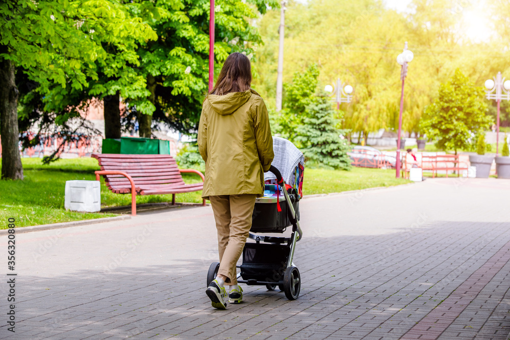 Mother wheeling a pram in the Park
Mother wheeling a pram in the Park