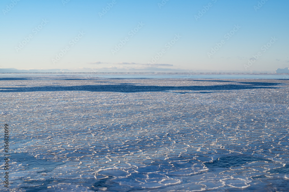 Frozen arctic ocean with pancake ice with blue sky Frozen arctic ocean with pancake ice with blue sky