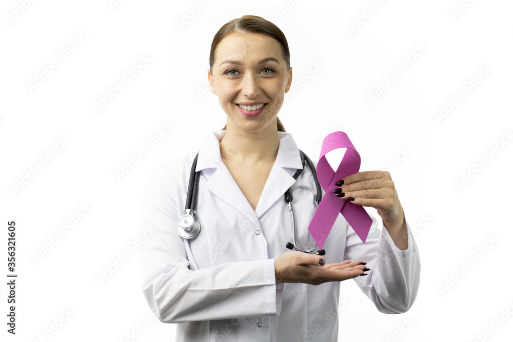 Beautiful broadly smiling female doctor in white medical coat and stethoscope showing pink ribbon isolated on white background with text space. Breast cancer awareness campaigns, symbol of october Beautiful broadly smiling female doctor in white medical coat and stethoscope showing pink ribbon isolated on white background with text space. Breast cancer awareness campaigns, symbol of october