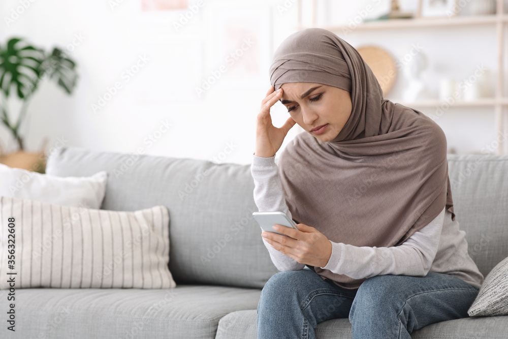 Stressed Muslim Woman In Hijab Waiting For Important Call At Home Stressed Muslim Woman In Hijab Waiting For Important Call At Home