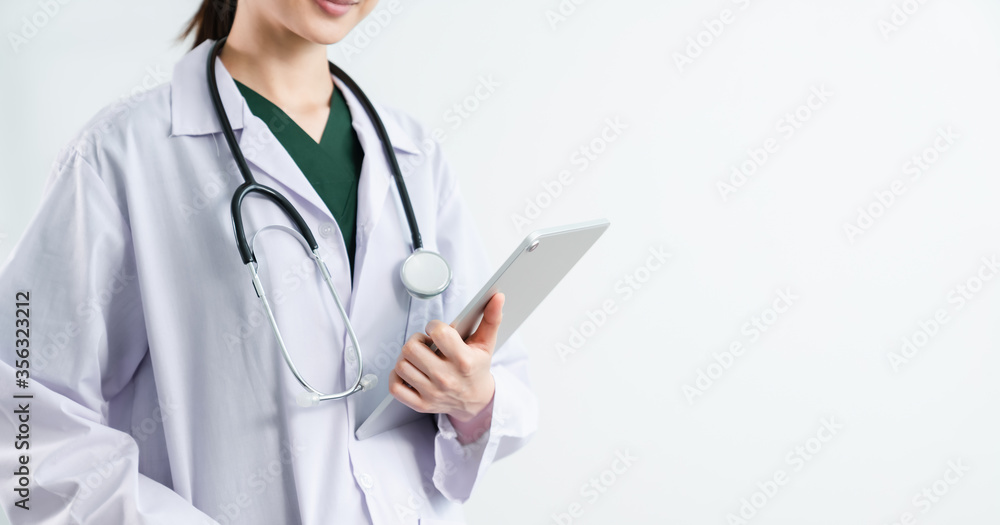 Doctor stands with stethoscope and digital tablet on the white background. Doctor stands with stethoscope and digital tablet on the white background.