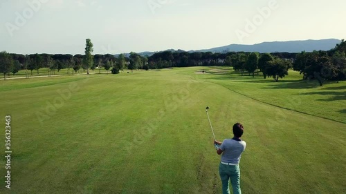 AERIAL WS Men playing golf on sunny day / Prato, Florence, Italy