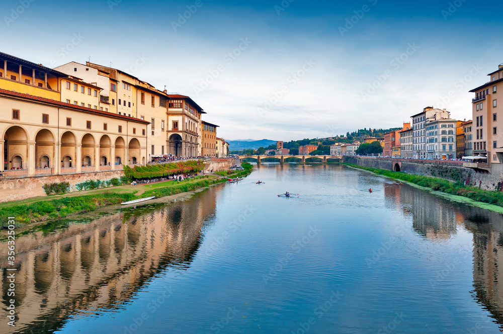 Scenic view of the Arno river, the main waterway of Tuscany region running through the medieval city of Florence in Italy
