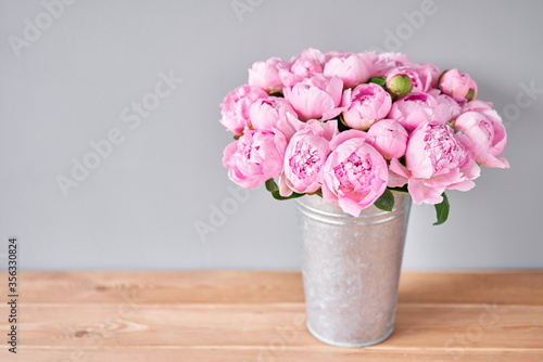 Fototapeta Naklejka Na Ścianę i Meble -  Pink Angel Cheeks peonies in a metal vase. Beautiful peony flower for catalog or online store. Floral shop concept . Beautiful fresh cut bouquet. Flowers delivery
