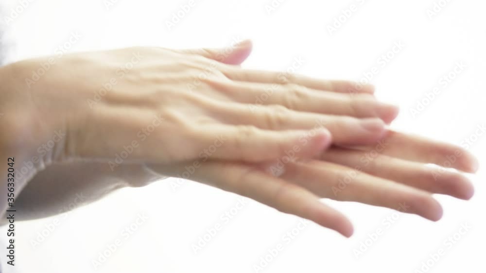 Woman hands washing with acohol gel on white for clean hygienic Woman hands washing with acohol gel on white for clean hygienic