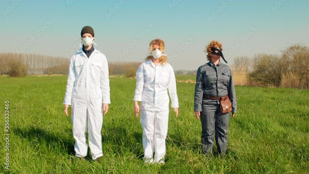 MS People wearing protective suits and masks standing in grassy field / Prinsenbeek, Noord-Brabant, Netherlands MS People wearing protective suits and masks standing in grassy field / Prinsenbeek, Noord-Brabant, Netherlands