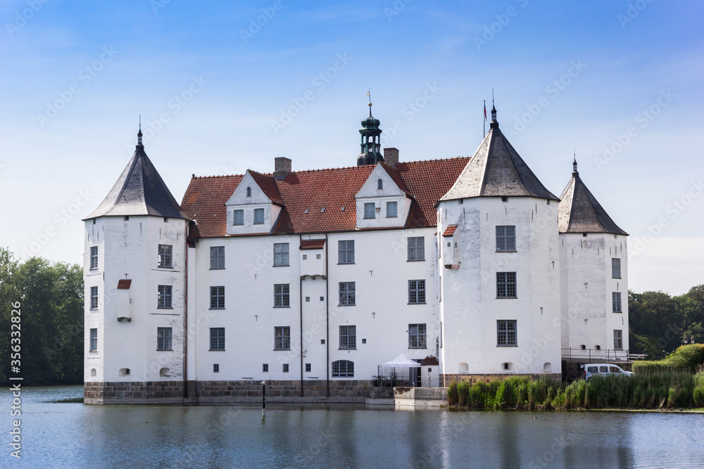 Historic white castle at the lake in Glucksburg, Germany
