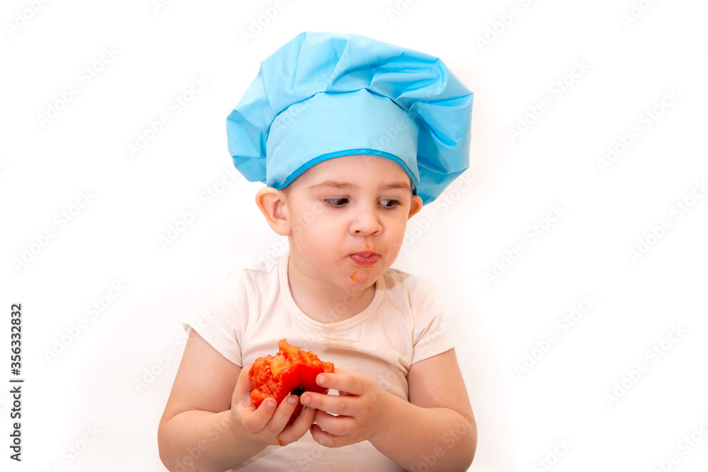 A little boy in a chef's hat cooks in a toy kitchen on a white background
A little boy in a chef's hat cooks in a toy kitchen on a white background