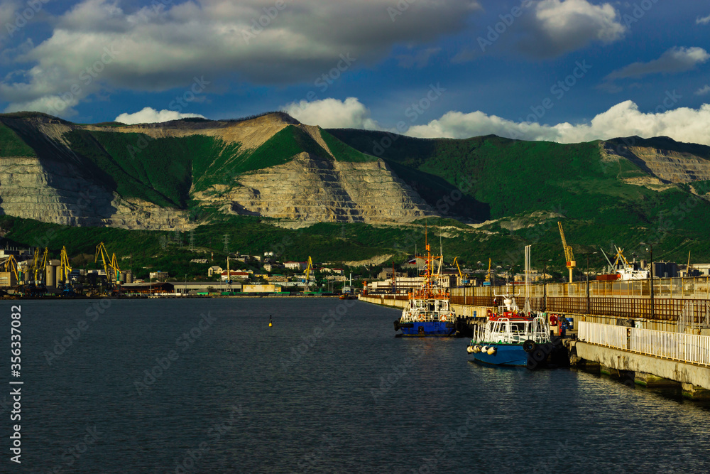 Tugboat at the pier in the port of Novorossiysk on a sunny day.