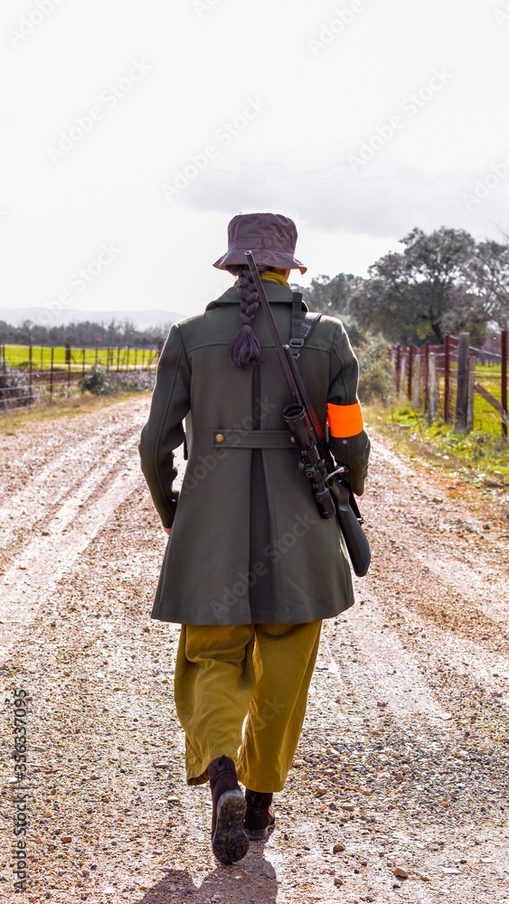 Young woman with a rifle returns from hunting in a spanish Montería. Young woman with a rifle returns from hunting in a spanish Montería.