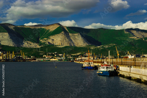 Tugboat at the pier in the port of Novorossiysk on a sunny day.
