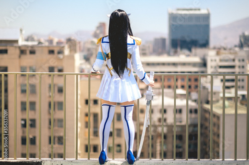 Принти на полотні Girl with craft made cosplay of anime from behind in the rooftop of a building i