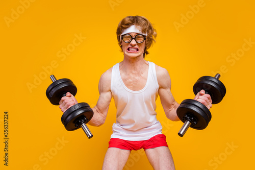 Portrait of his he nice attractive funky motivated guy sportsman lifting heavy barbell endurance hard regime plan isolated over bright vivid shine vibrant yellow color background photo