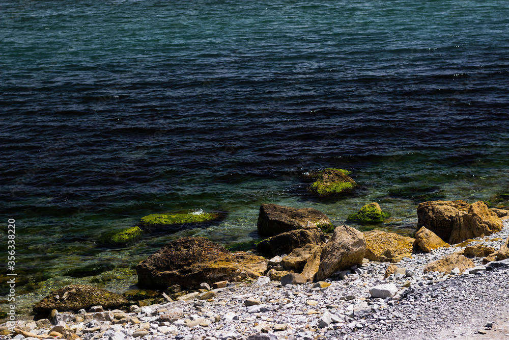 Wet mossy rocks on the coastline of Novorossiysk.