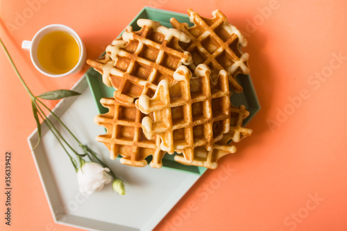 Viennese waffles on coral background