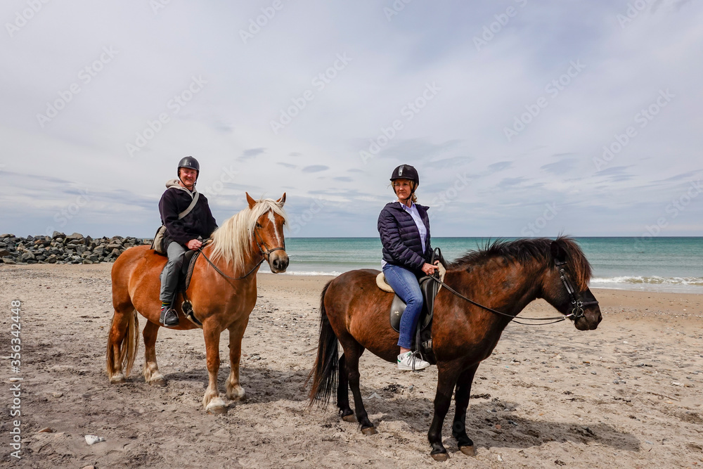 Hirtshals, Denmark A middle-aged woman goes horseback riding on the beach. Hirtshals, Denmark A middle-aged woman goes horseback riding on the beach.