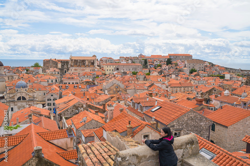 Asian female tourist in Dubrovnik old town, World heritage travelling destination in Croatia