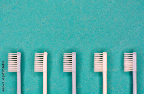 Clean toothbrushes laid out on the background for inscription text about oral...